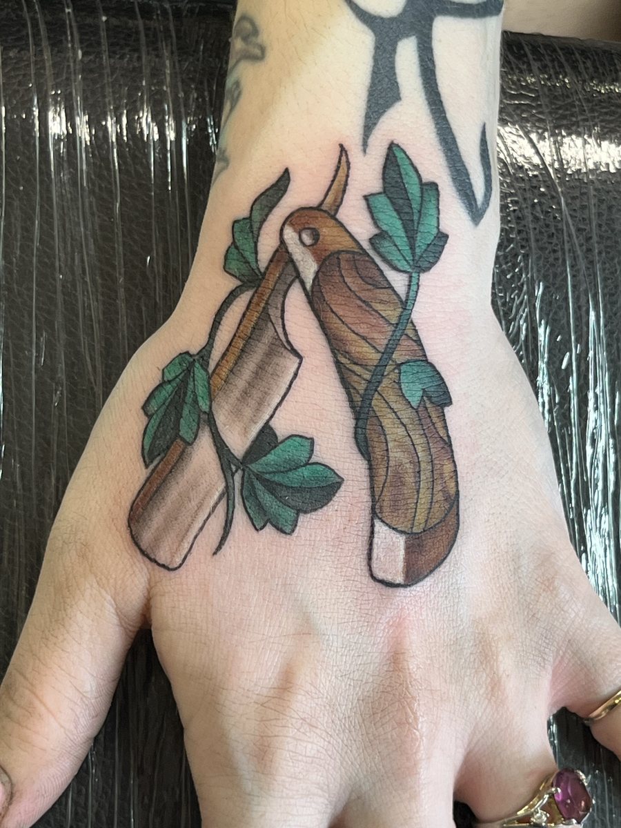 Color forearm tattoo of rolled joints and cannabis leaves by Shawn Lowe at Fargo Tattoo in Fargo, North Dakota