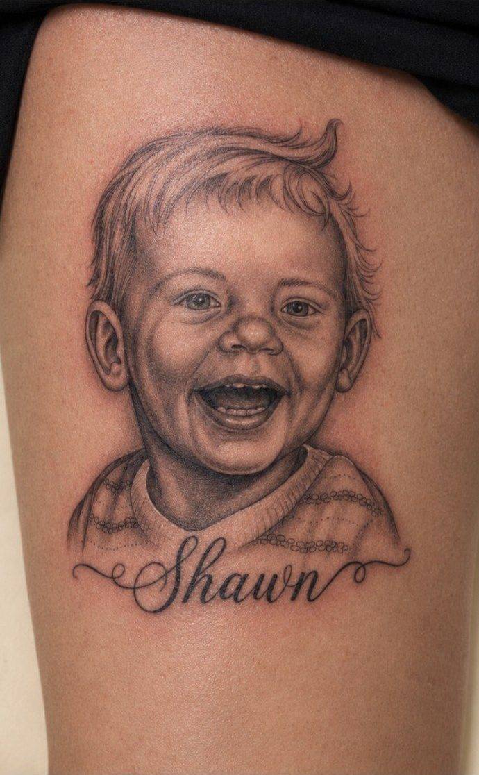 Finished black and grey child portrait tattoo with Shawn script by Fargo Tattoo