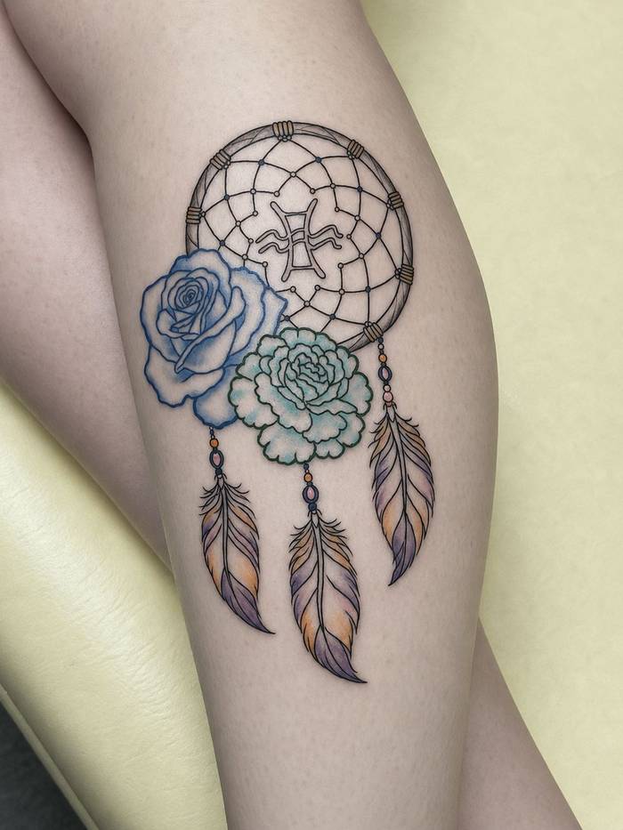 Color dreamcatcher tattoo with roses and feathers by Shawn Lowe at Fargo Tattoo in Fargo, North Dakota