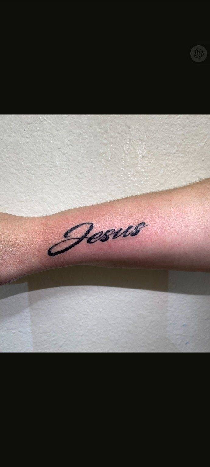 Fresh Jesus cursive script forearm tattoo by Shawn Lowe at Fargo Tattoo in Fargo, North Dakota