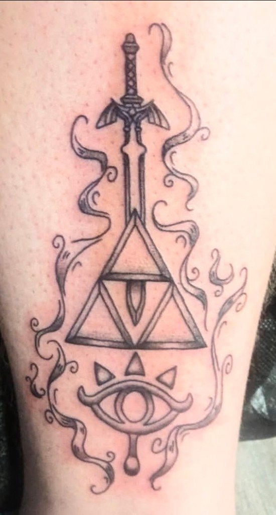 Black and grey illustrative tattoo of the Master Sword, Triforce, and Sheikah Eye with smoke swirls by Leni B. at Fargo Tattoo in Fargo, North Dakota